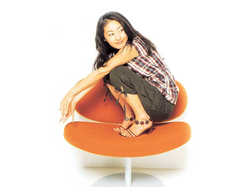 Woman Sitting on Orange Chair — Calm