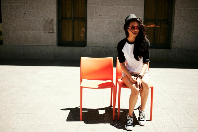 woman sitting on orange chair