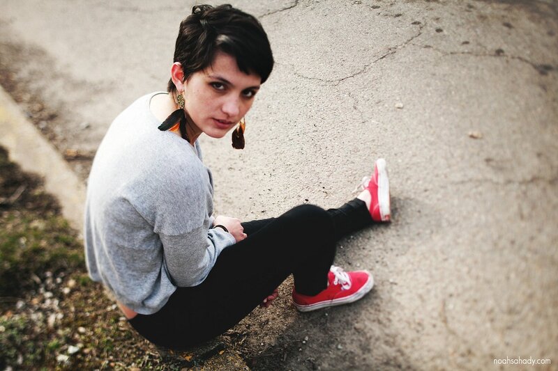 woman sitting on pavement