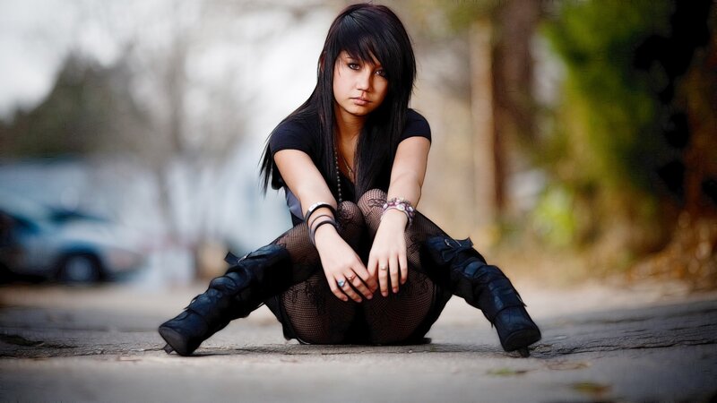 woman sitting on pavement