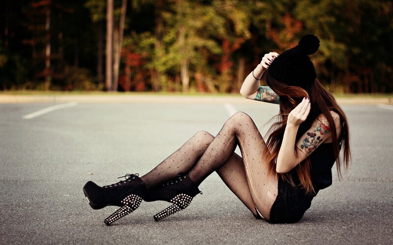 woman sitting on pavement