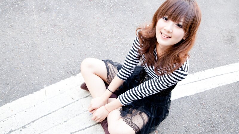 woman sitting on pavement