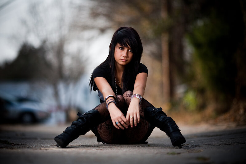 woman sitting on pavement