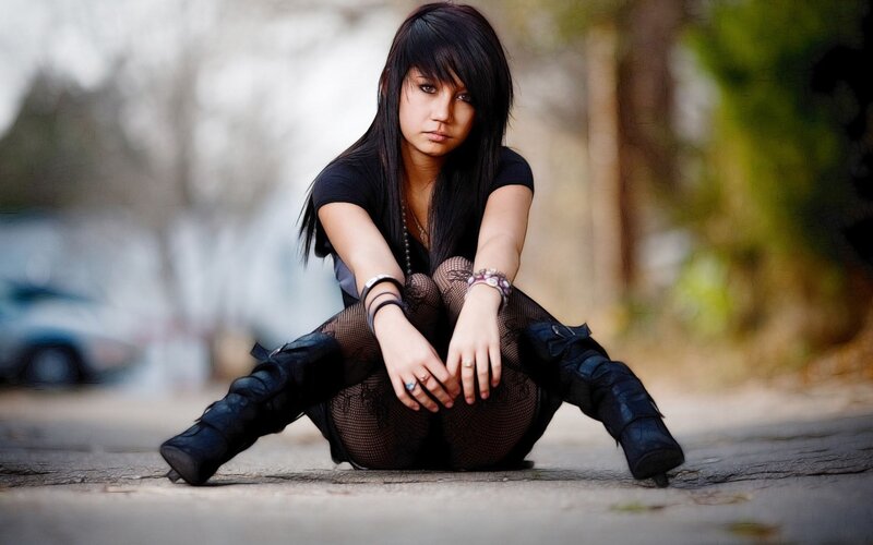 woman sitting on pavement