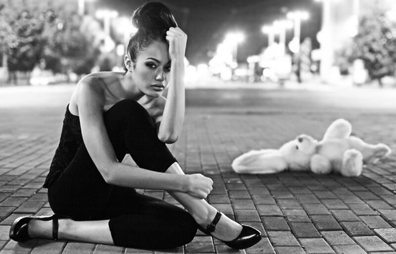 Woman Sitting on Pavement — Black, Dramatic