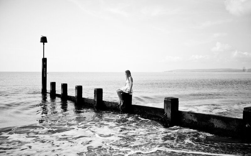woman sitting on pier