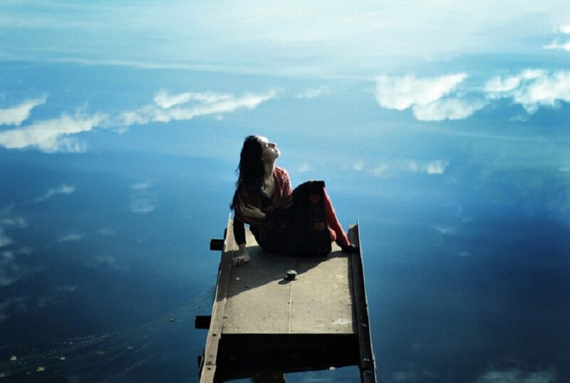 Woman Sitting on Pier — Blue