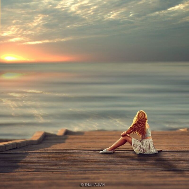 Woman Sitting on Pier — Orange, Serene