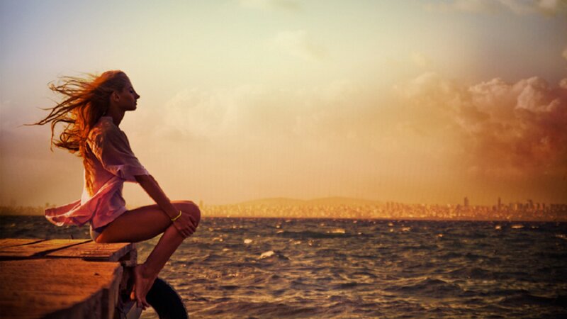 Woman Sitting on Pier — Orange