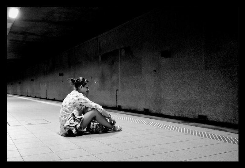 Woman Sitting on Platform — Black