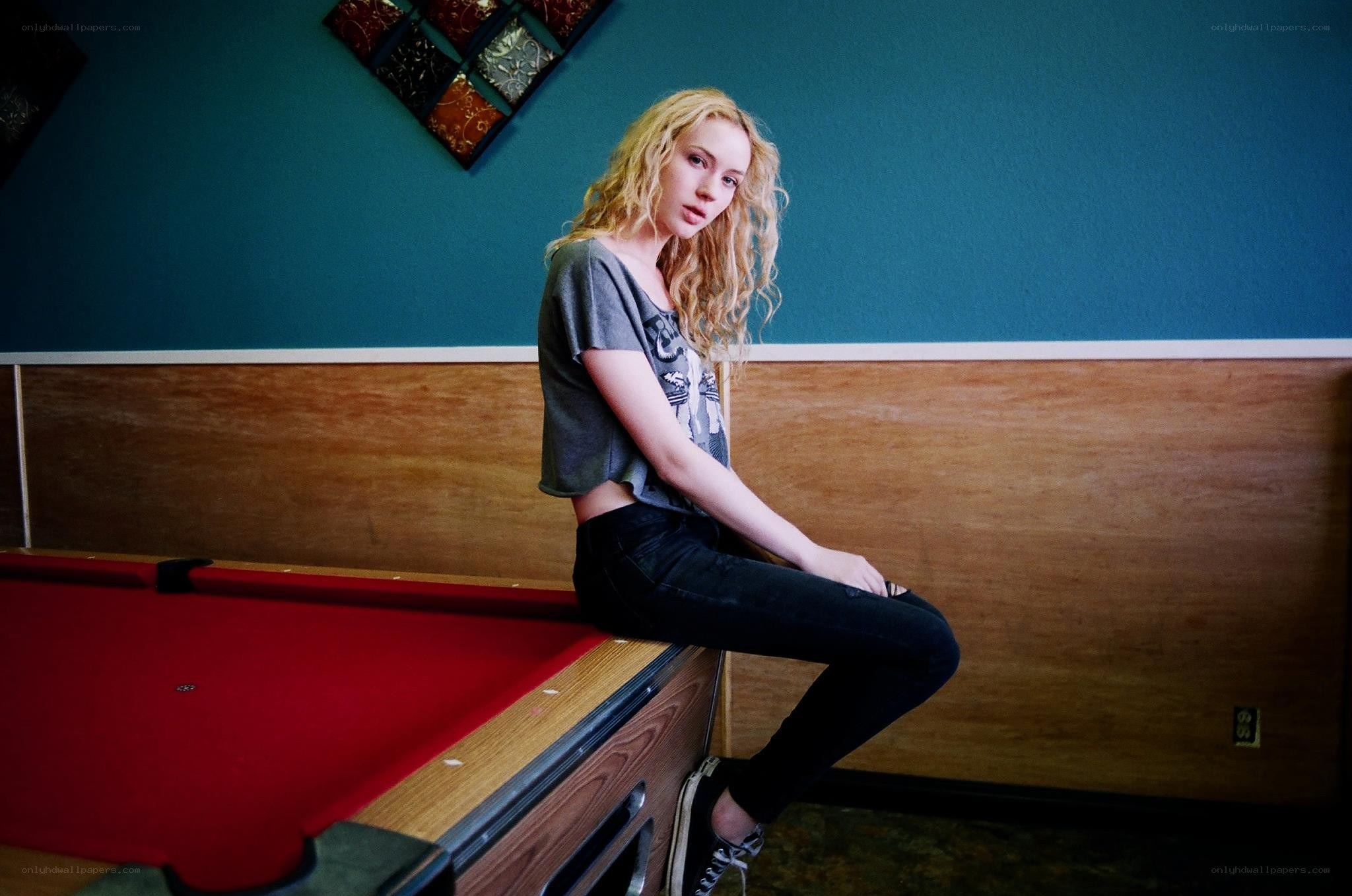 woman sitting on pool table
