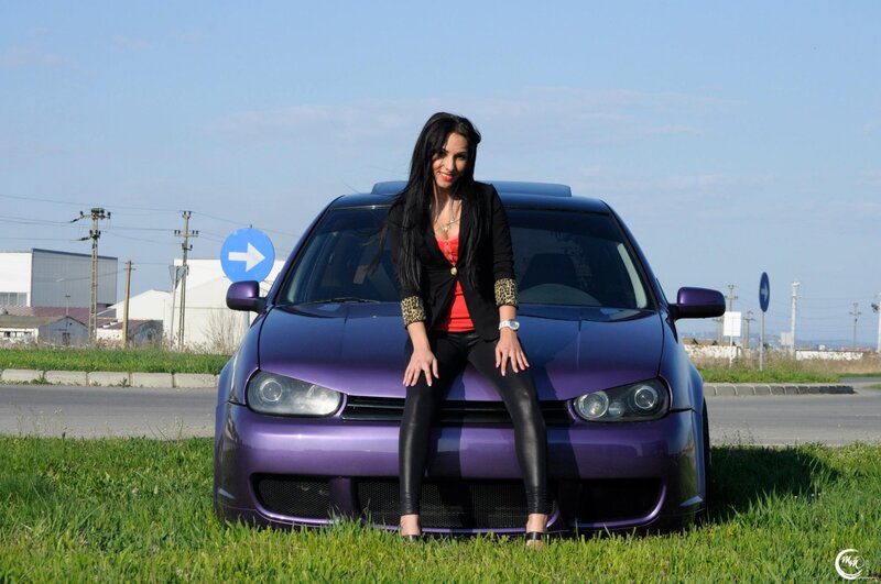 woman sitting on purple car