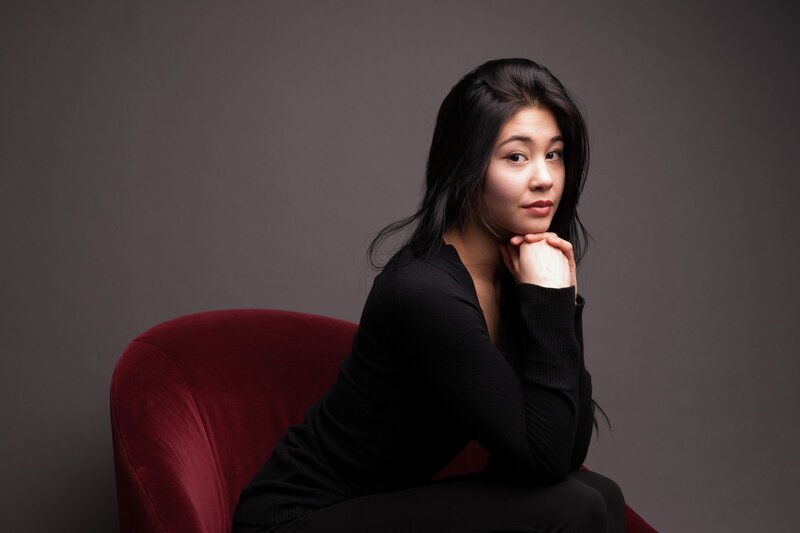 woman sitting on red chair