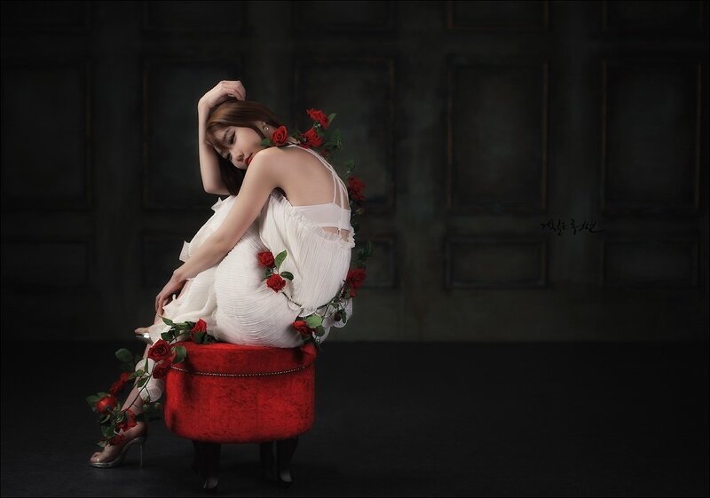 Woman Sitting on Red Stool — White, Dramatic