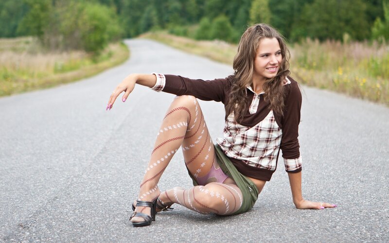 woman sitting on road