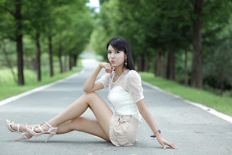 woman sitting on road
