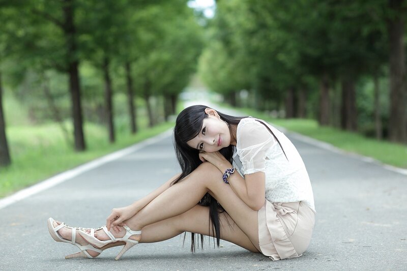 woman sitting on road