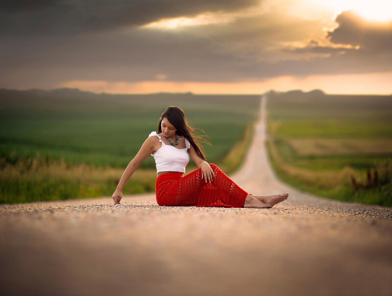 Woman Sitting on Road — Red