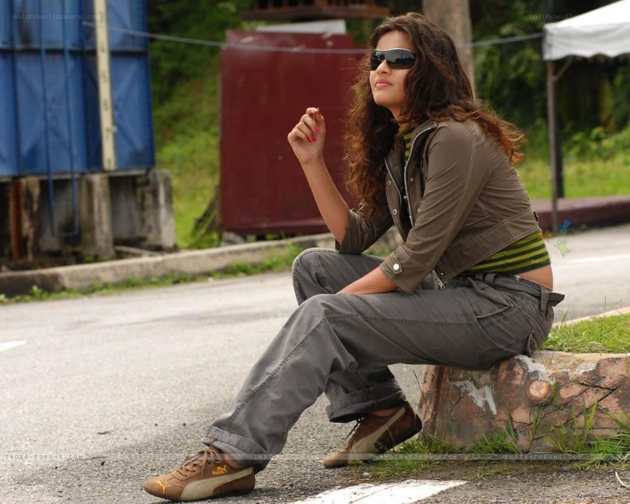woman sitting on roadside curb