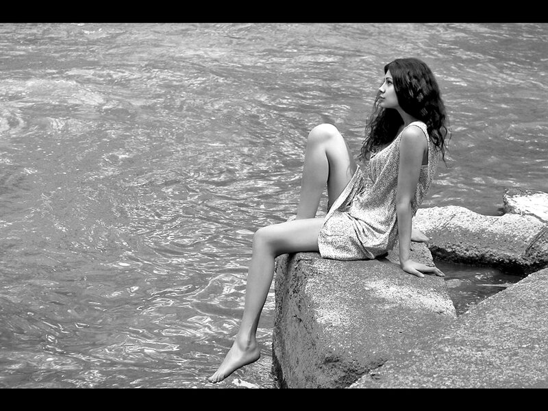 Woman Sitting on Rock — Black, Contemplative