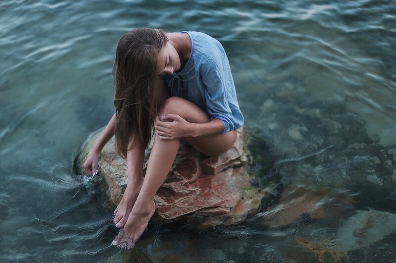 Woman Sitting on Rock — Blue, Calm