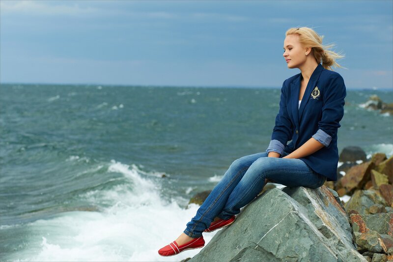 Woman Sitting on Rock — Blue, Serene, Afternoon, Photograph, Ocean, Rocks, Blonde Hair, Gray
