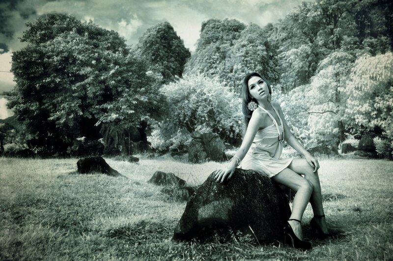 Woman Sitting on Rock — Green, Dramatic
