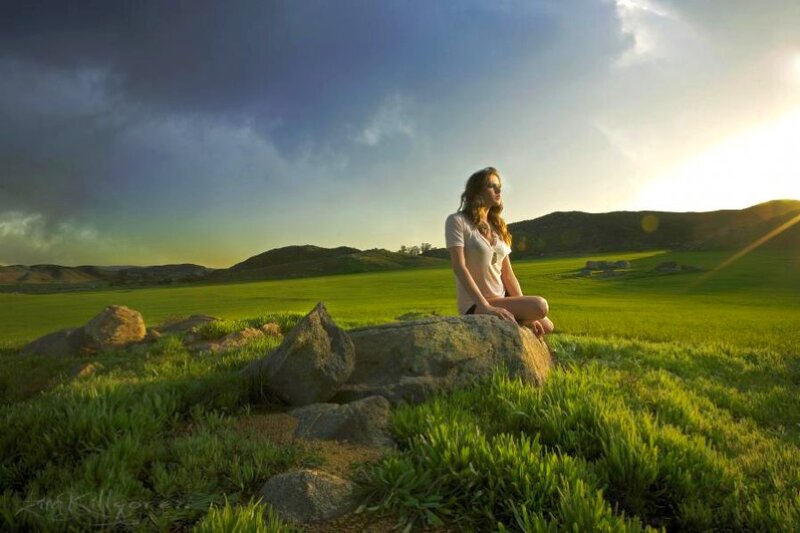 Woman Sitting on Rock — Green, Serene