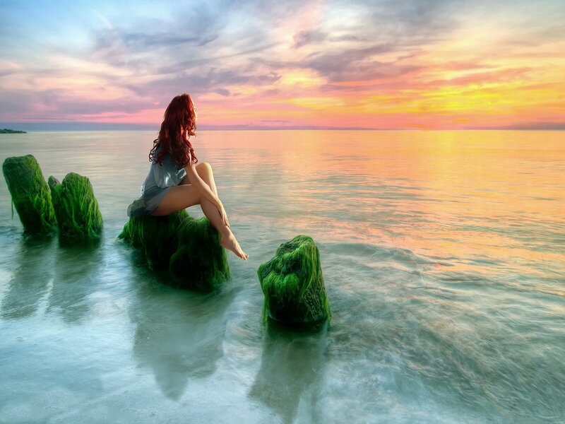 Woman Sitting on Rock — Orange, Serene, Sunset