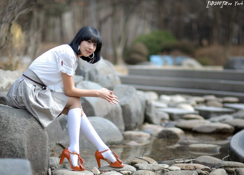 Woman Sitting on Rock — White, Serene, Autumn, Photograph