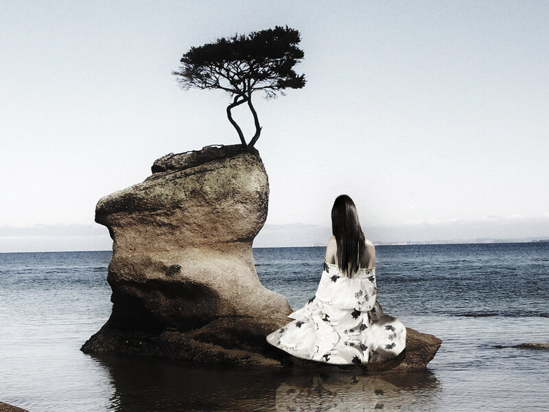 Woman Sitting on Rock — White, Serene
