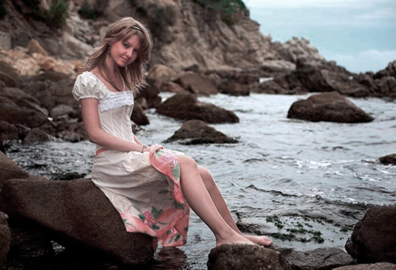 Woman Sitting on Rock — White