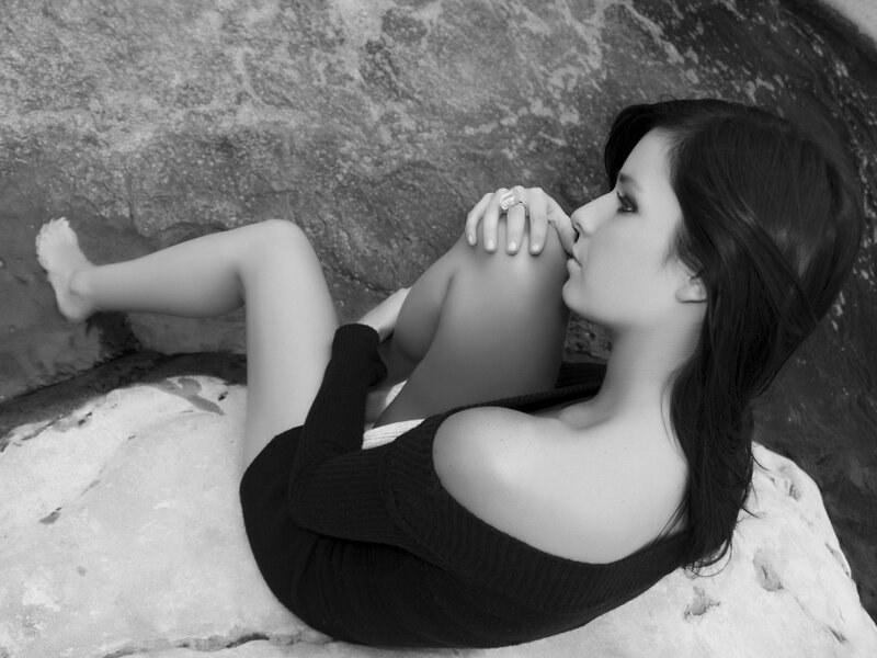 woman sitting on rocks