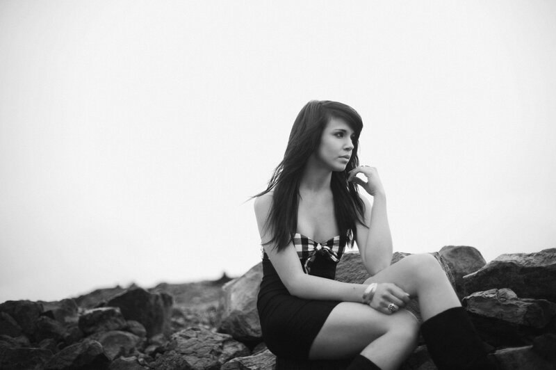woman sitting on rocks