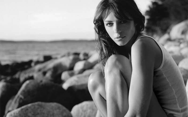 Woman Sitting on Rocks — Black, Contemplative, Sunset, Photograph, Sea