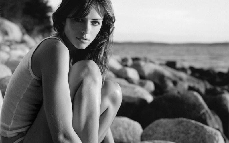 Woman Sitting on Rocks — Black, Contemplative, Sunset, Photograph