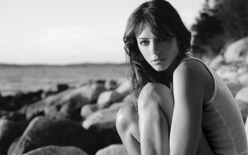 Woman Sitting on Rocks — Black, Contemplative