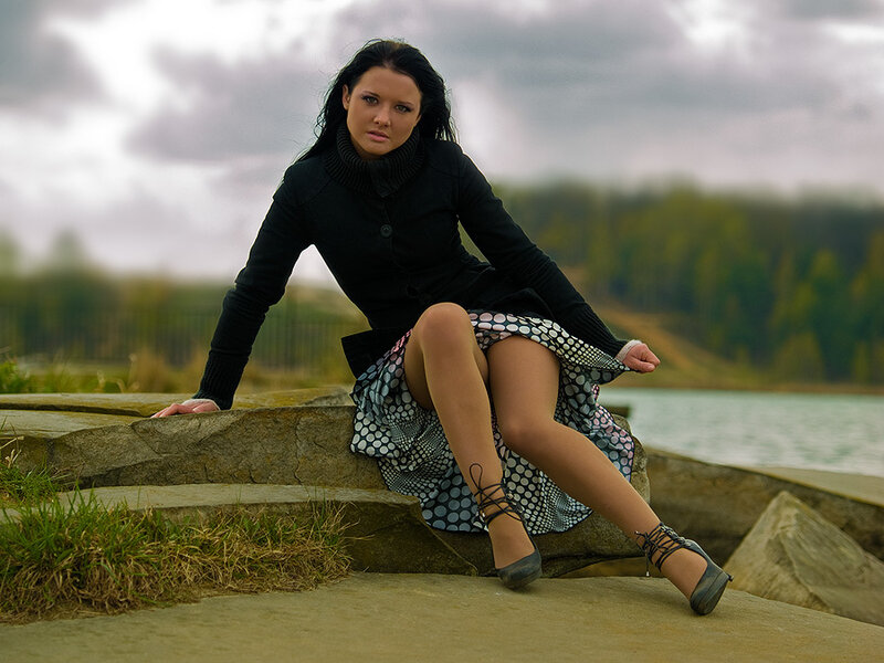 Woman Sitting on Rocks — Black, Dramatic