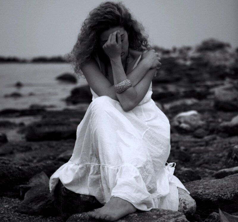 Woman Sitting on Rocks — Black, Melancholic