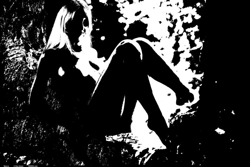 Woman Sitting on Rocks — Black