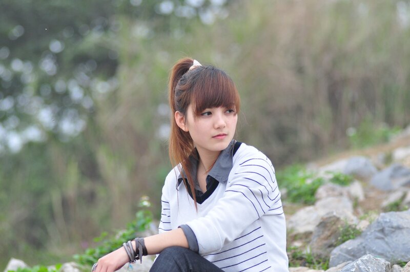woman sitting on rocks outdoors