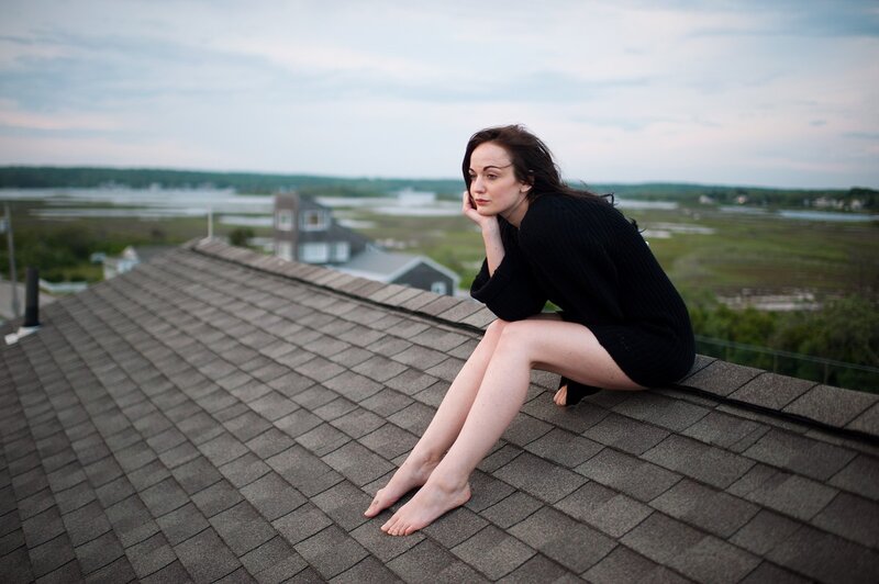 Woman Sitting on Roof — Gray