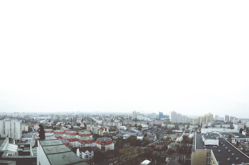 Woman Sitting on Rooftop — Gray, Overcast