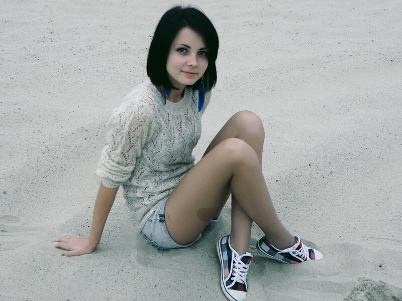 woman sitting on sand
