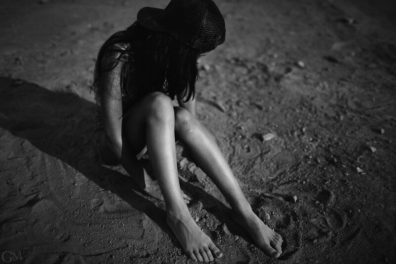 woman sitting on sand at night