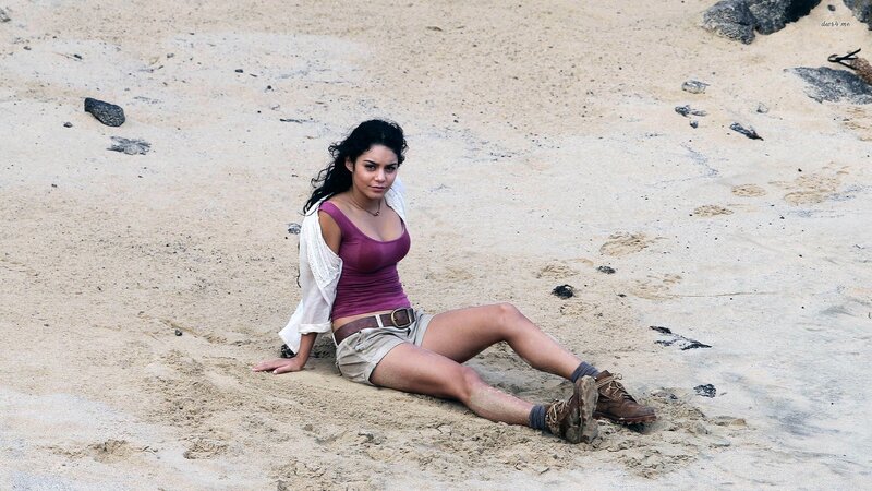 woman sitting on sandy beach