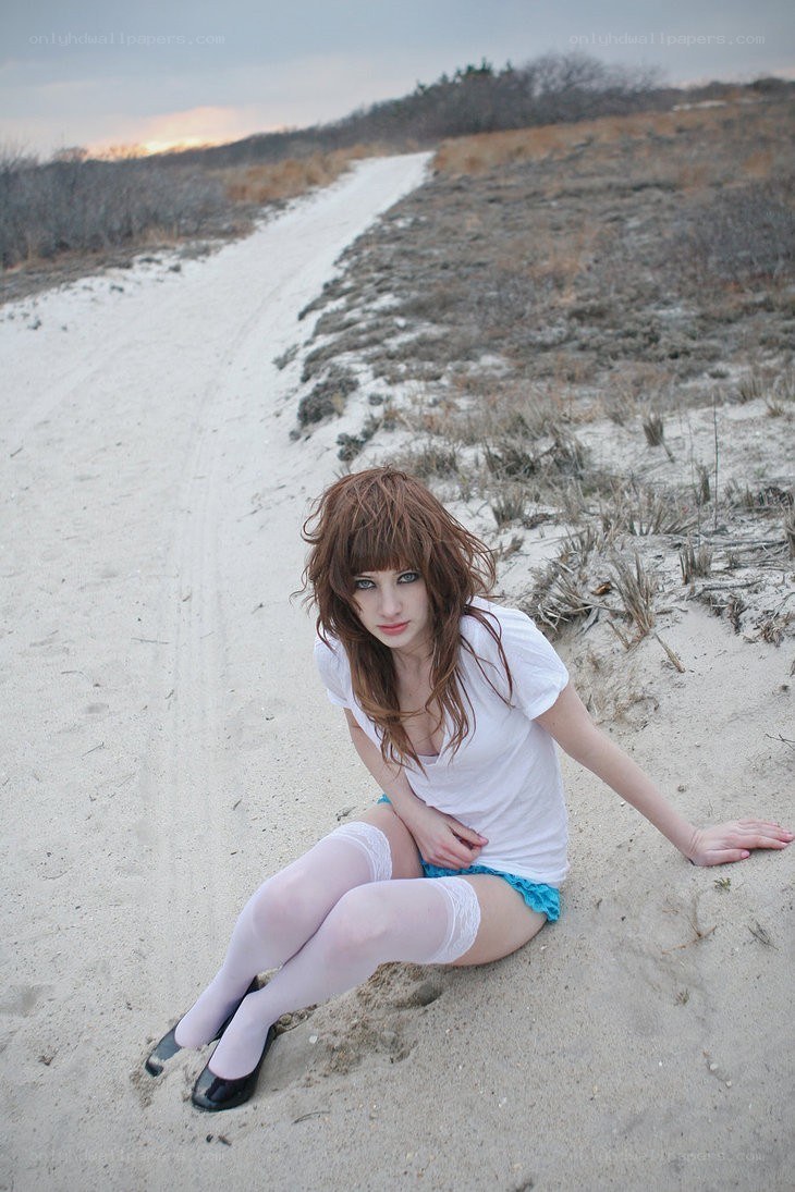woman sitting on sandy path