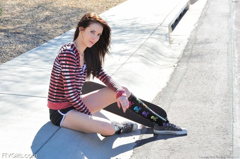woman sitting on sidewalk