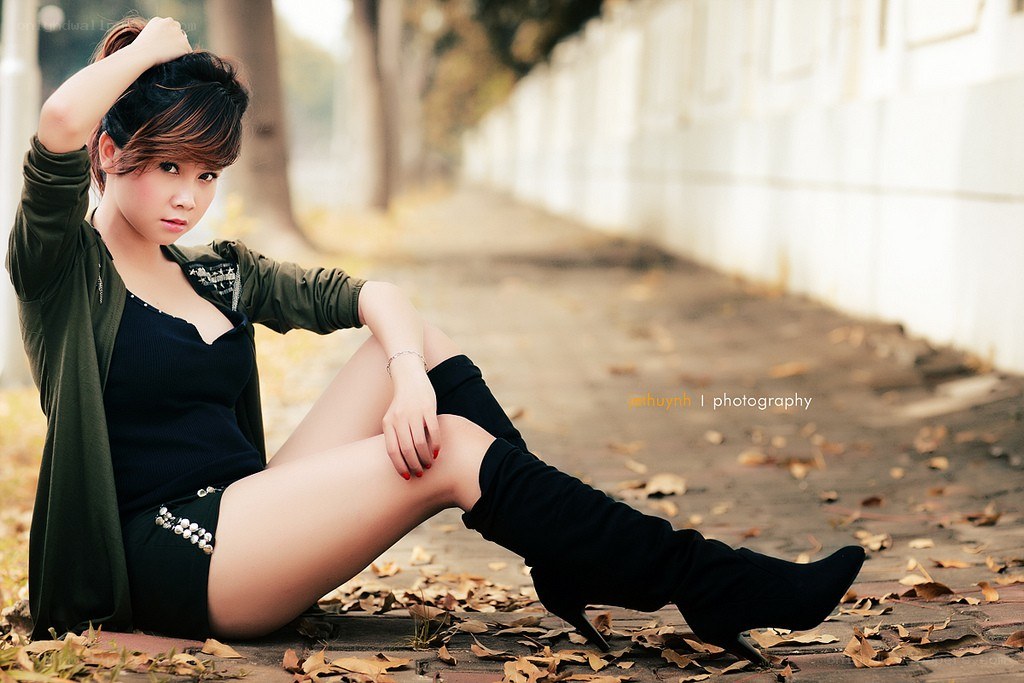 woman sitting on sidewalk