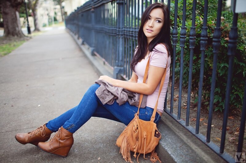 woman sitting on sidewalk